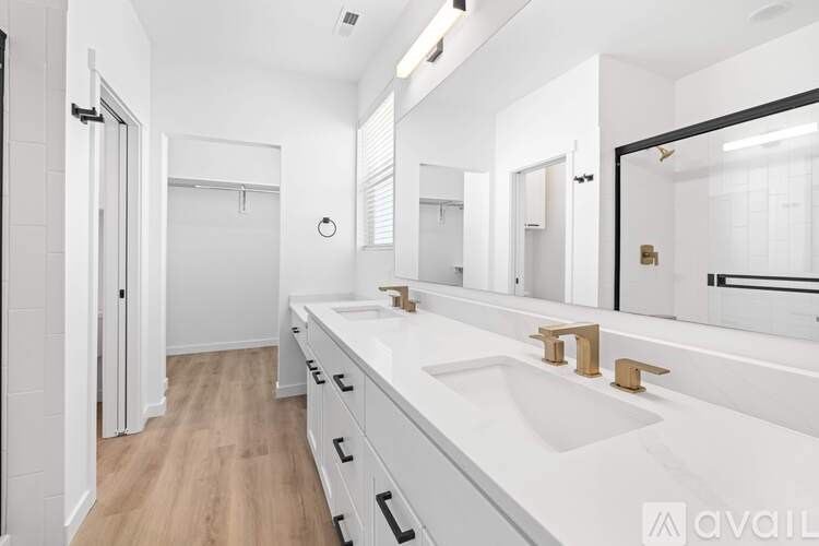 A bathroom with a white sink and a mirror.