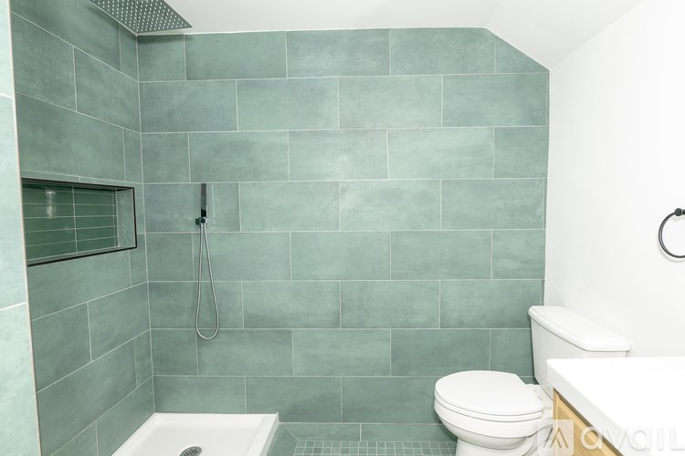 A bathroom with a white toilet and a shower with a glass door.