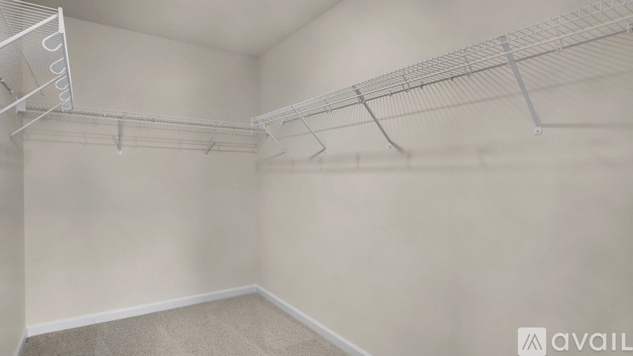 Empty room with white walls and a carpeted floor.