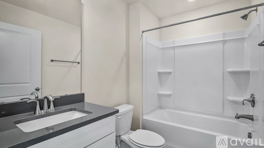 A bathroom with a sink, toilet, and bathtub.