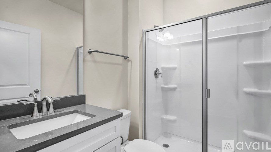 A bathroom with a sink, toilet, and shower.