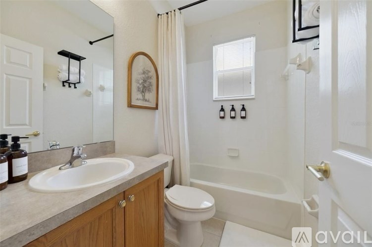 A bathroom with a sink, toilet, and bathtub.