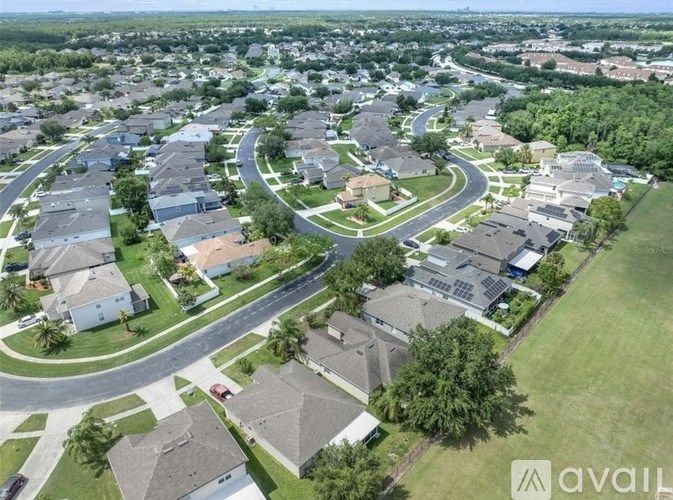 A bird's eye view of a residential area with houses and roads.