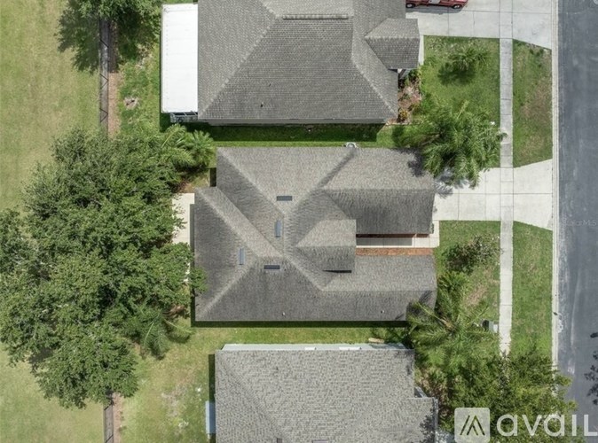 A bird's eye view of a residential area with houses and trees.