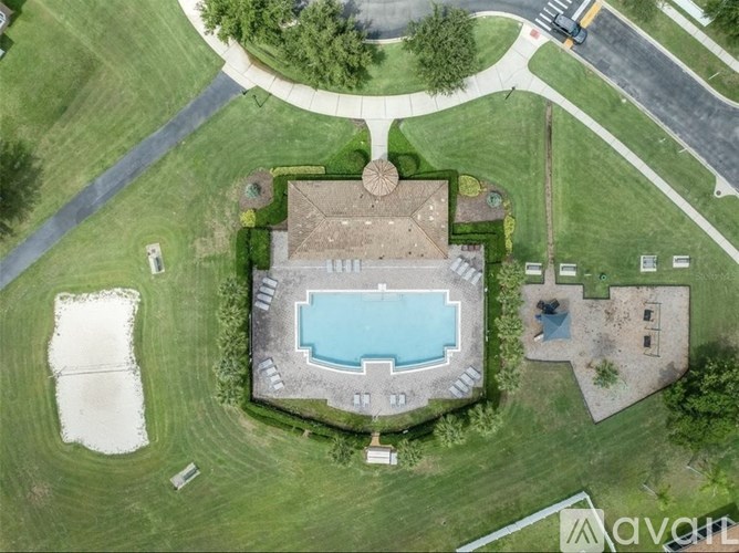 A large backyard with a swimming pool and a house.
