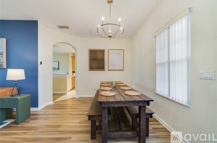 A dining room with a wooden table and benches.