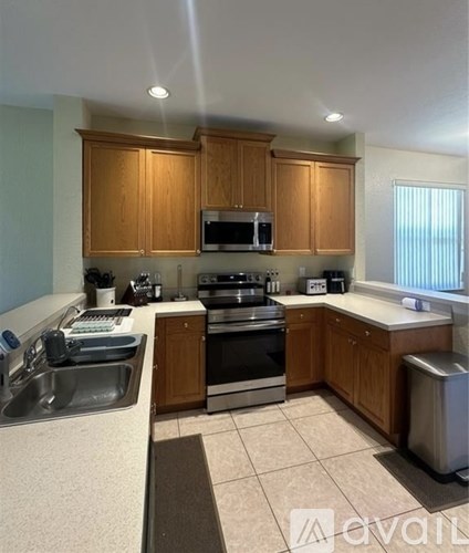 A kitchen with wooden cabinets and stainless steel appliances.