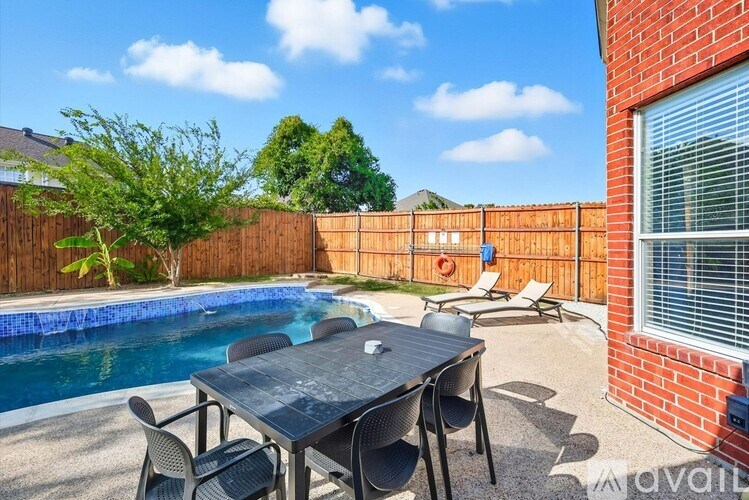 A backyard with a pool and a dining table.