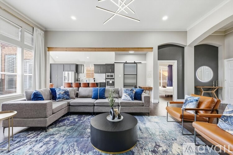 A modern living room with a grey sofa and a round coffee table.