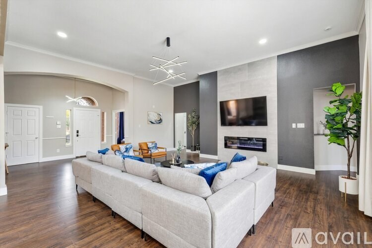 A living room with a large couch and a television.