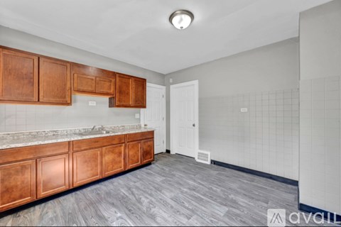 A kitchen with wooden cabinets and a white door.