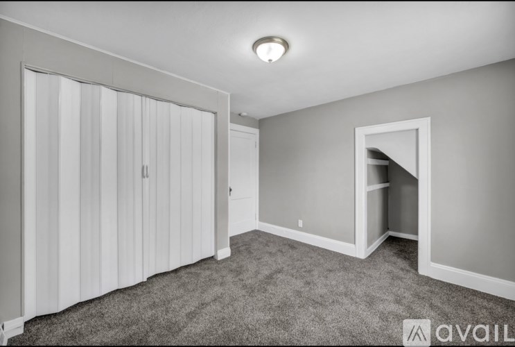 A room with a carpeted floor and a sliding door.
