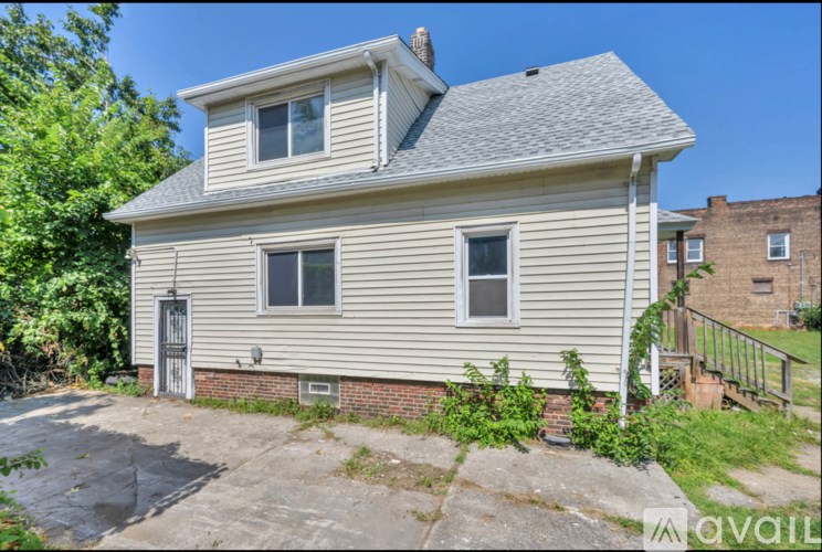 A house with a grey roof and a garage door.