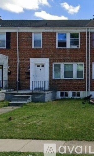 A brick house with a white door and windows.