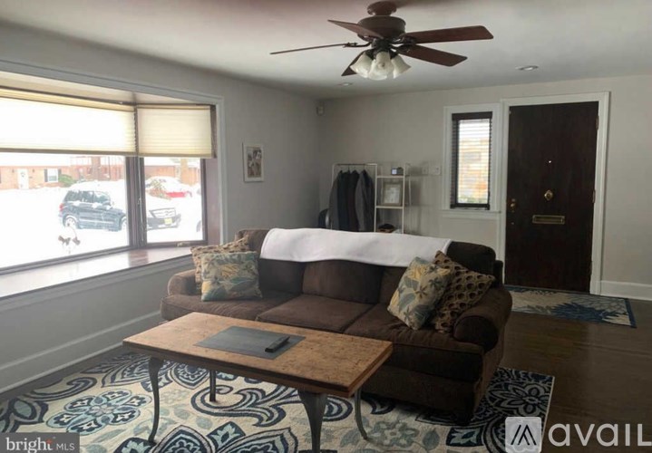 A living room with a brown couch and a coffee table.