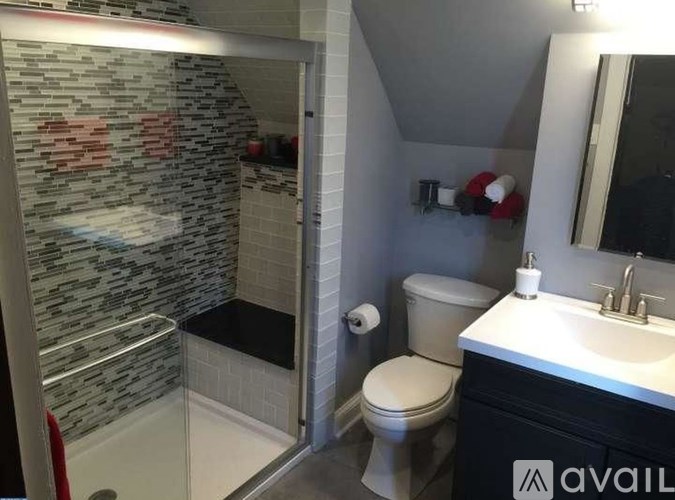 A bathroom with a toilet, sink, and shower.
