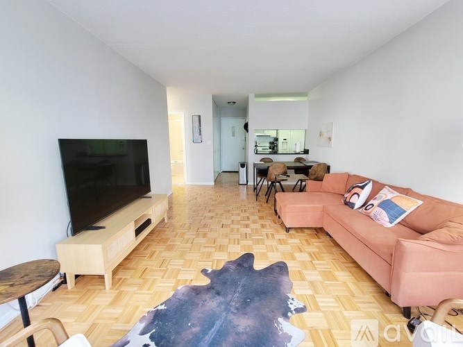 A living room with a television, couch, and coffee table.