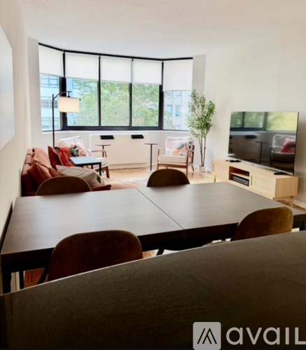 A living room with a large table and chairs.