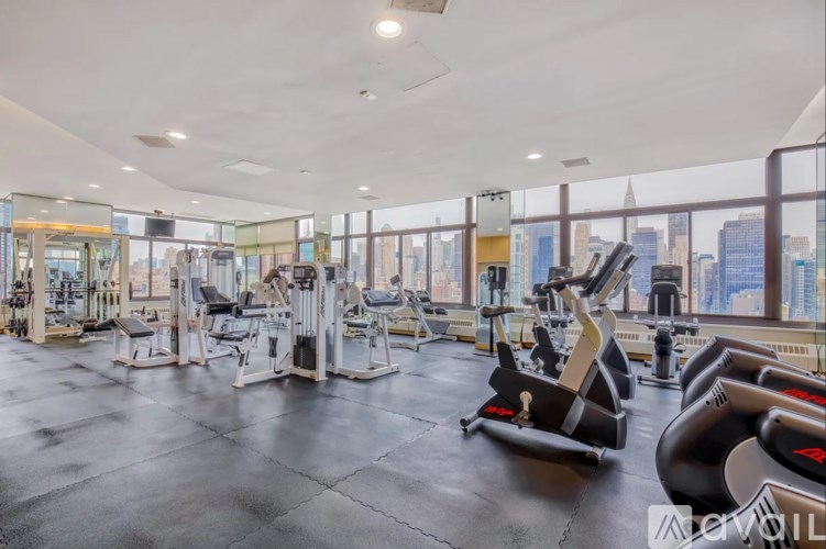 A gym with a view of the city skyline.