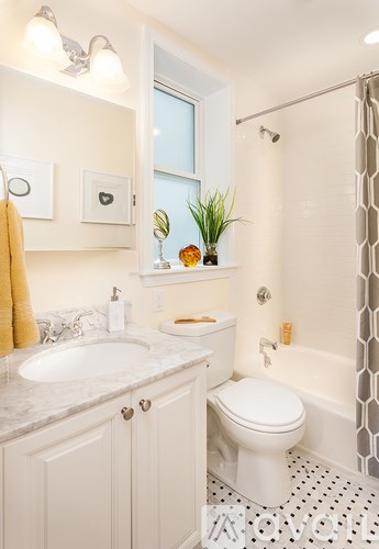 A white toilet sits next to a sink in a bathroom.