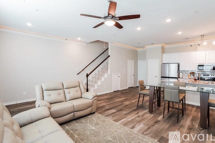 A living room with a white sofa and a wooden floor.