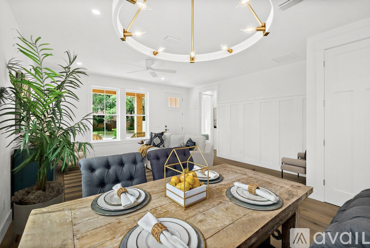 A dining room with a wooden table set for a meal.