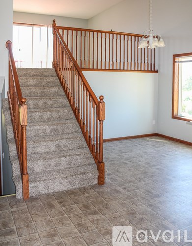 A staircase with wooden balusters and a carpeted runner.
