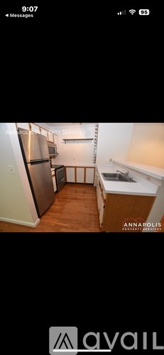 A kitchen with wooden floors and white walls.