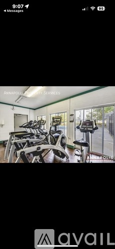 A gym with exercise equipment and a sign that says "Annapolis Fitness Services".