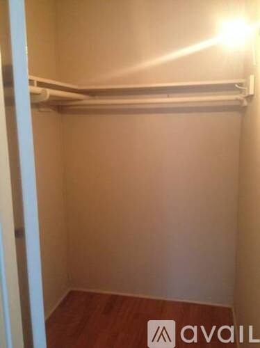 A small, empty room with a shelf and a light on.