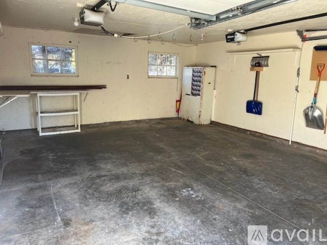 A bathroom with a toilet, sink, and a map on the wall.