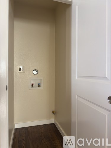A room with a window and wooden floors.