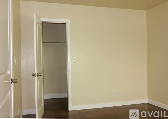 A room with a door and a wall socket.
