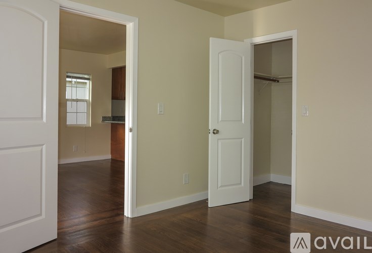 A room with a white door and a window.