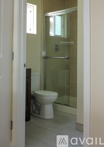 A bathroom with a toilet and a walk in shower.