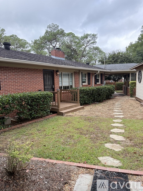 A house with a brick exterior and a front porch.