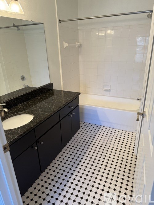 A beach volleyball court with a net and a sign that reads "Stella MLS".