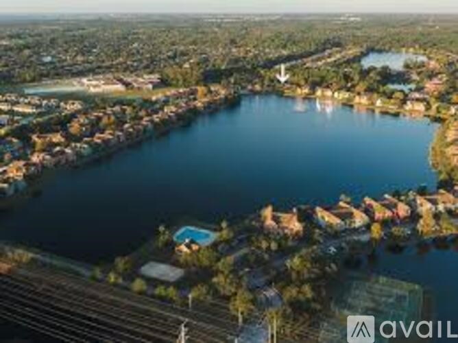 A bird's eye view of a residential area with a large lake in the foreground.