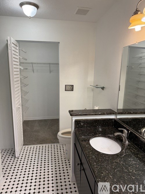 A room with a ceiling fan and a window with blinds.