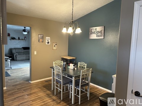 A dining room with a table set for four.