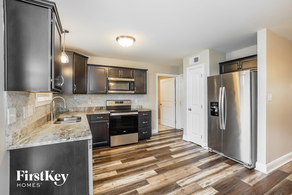 A kitchen with a FirstKey Homes logo on the counter.