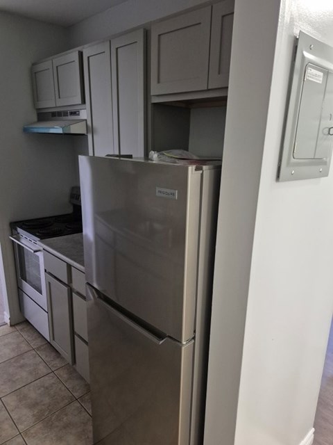 A stainless steel refrigerator in a kitchen.