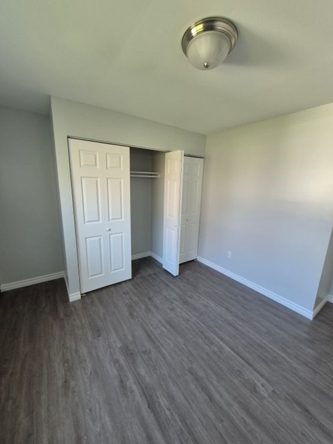 A room with a white door and a light on the ceiling.
