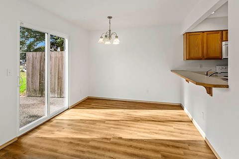 A room with wooden floors and a chandelier.