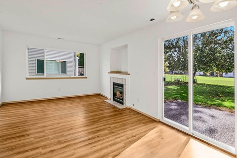 A room with a fireplace and sliding glass doors.