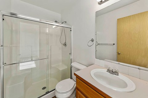 A white toilet sits next to a sink in a bathroom.
