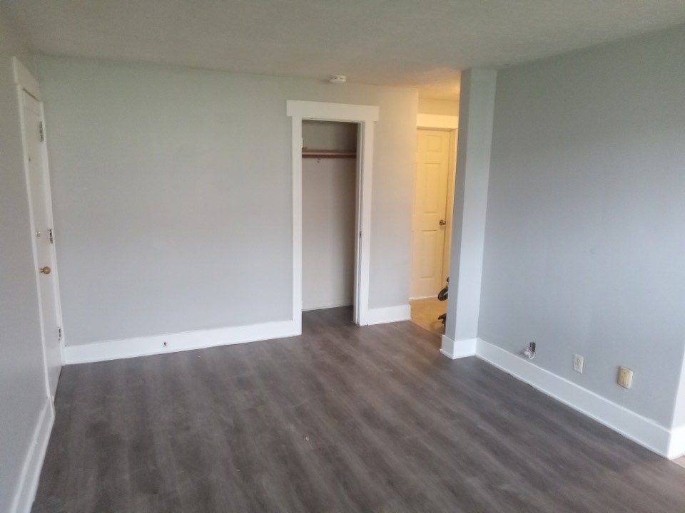 A room with a grey floor and white walls.