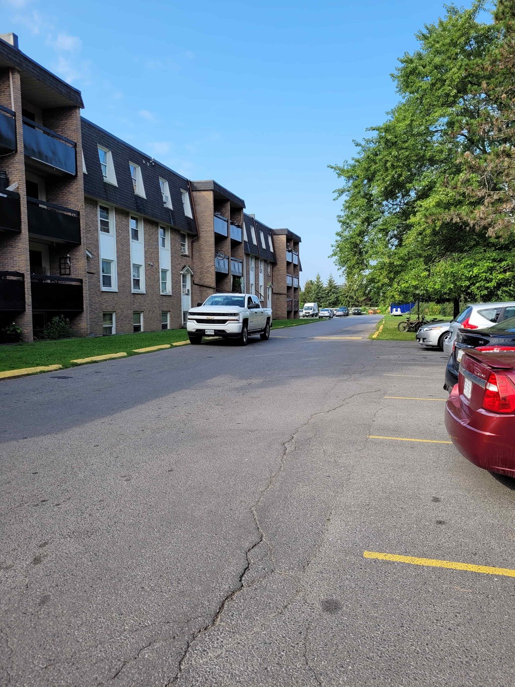 A white car is parked on the side of a street.