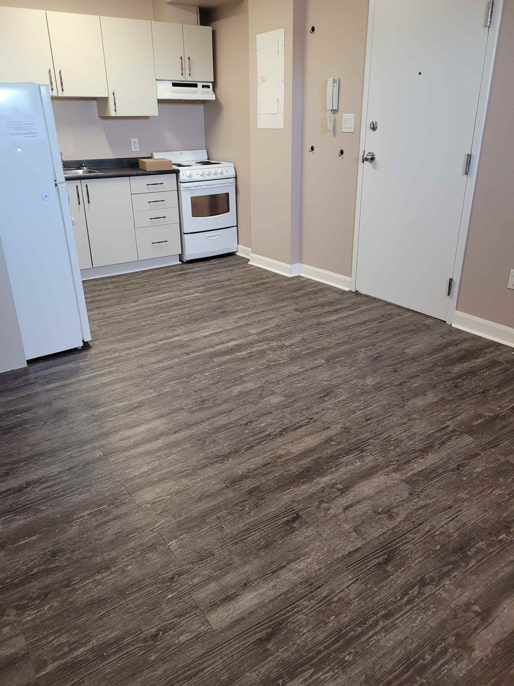 A kitchen with a white fridge and white oven.