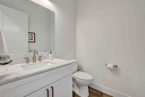 A white toilet sits next to a sink in a bathroom.